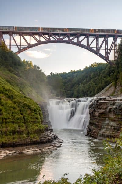 A train passing over Upper Falls at Letchworth State Park in New York