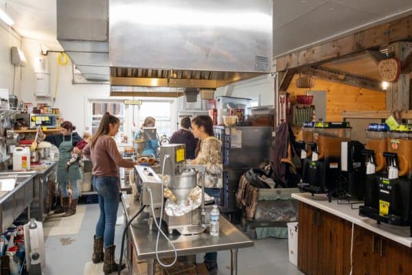 Workers making apple cider donuts at Burrville Cider Mill in Upstate New York