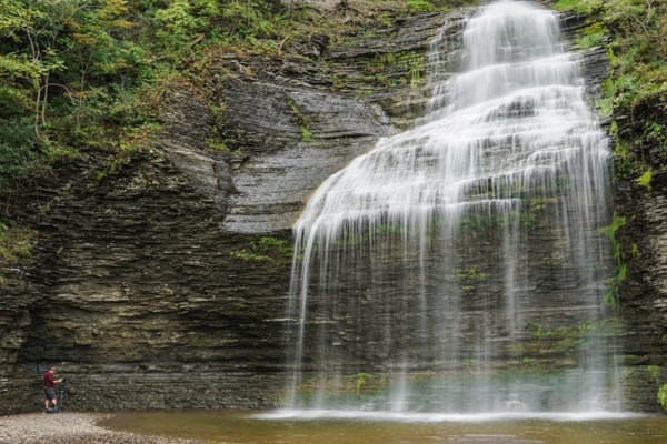 Man standing at the base of Aunt Sarah Falls in Montour Falls NY