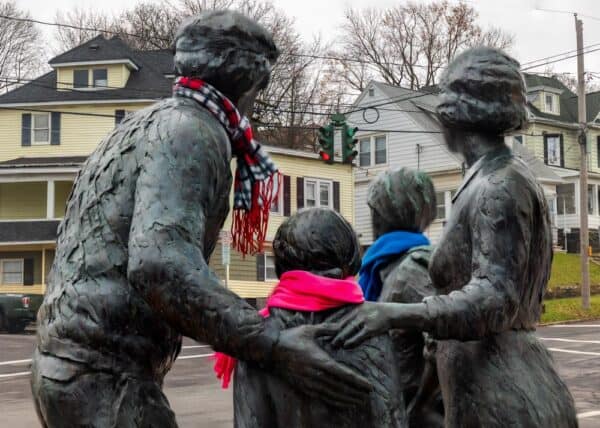 Statue looking towards the upside-down traffic light in Syracuse NY