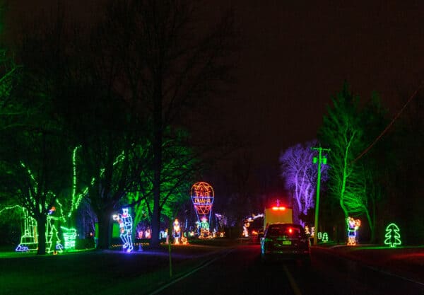 Cars sitting between holiday lights at Syracuse's Lights on the Lake