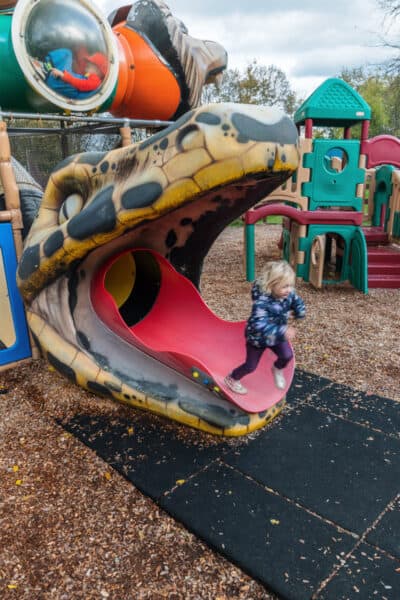 Child running out of a slide at the Utica Zoo in New York