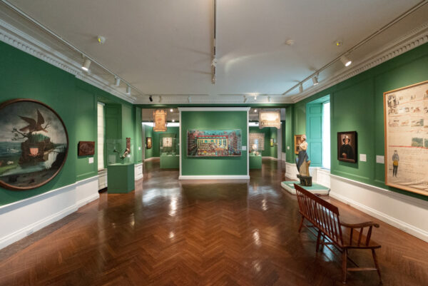 Green walled gallery of folk art in the Fenimore Art Museum in Otsego County New York