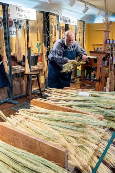 An artisan making brooms at the Farmers' Museum in Otsego County NY