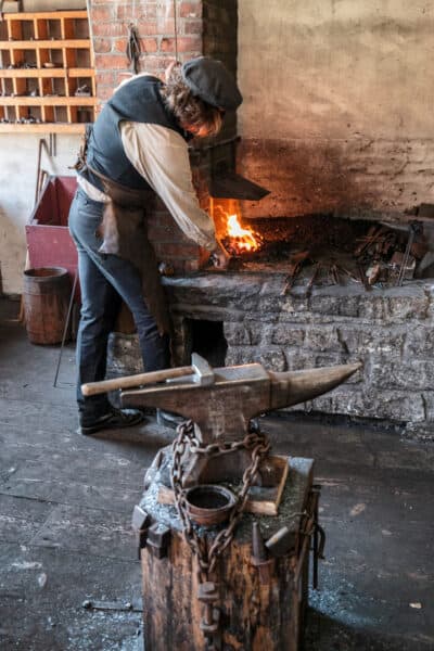 A blacksmith working on metal at the Farmers' Museum in Central New York