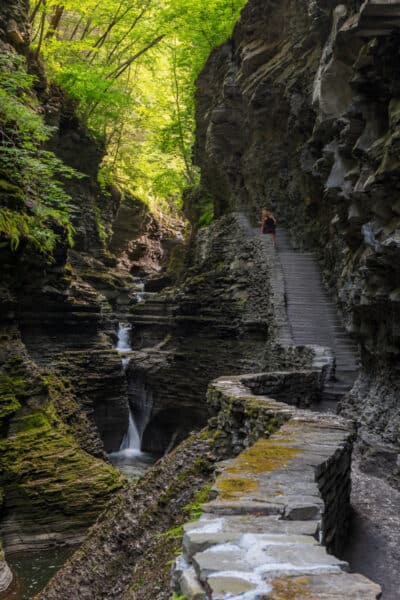 Person hiking up the stairs at Watkins Glen State Park in New York's Finger Lakes.