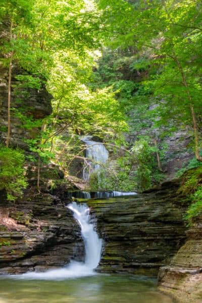 Waterfalls on a forested lined Catlin Mill Brook in Montour Falls New York