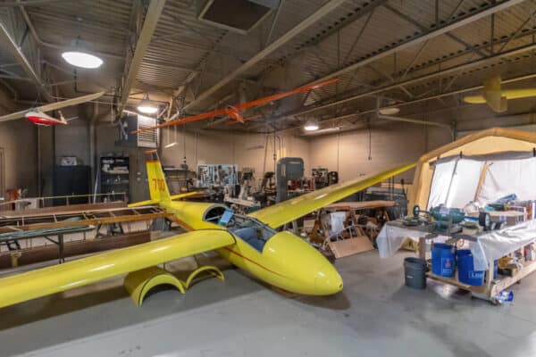 Yellow glider being refurbished at the National Soaring Museum in New York
