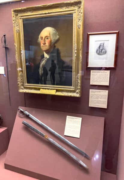 Portrait over George Washington hangs over swords at the West Point Military Museum in New York