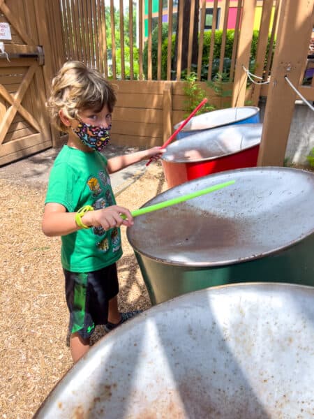 Boy plays with steel drums at the Sciencenter in Ithaca New York