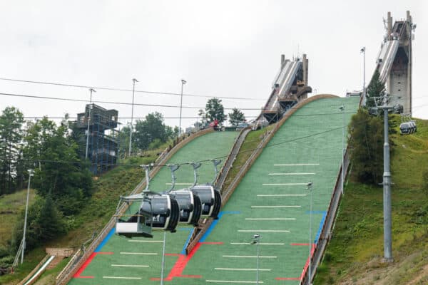 Gondolas going up the hill in front of the hills at the Olympic Ski Jumping Center in Lake Placid, New York