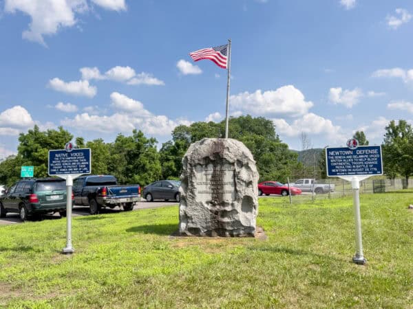 Stone monument and flag near the Newtown Battlefield State Park in Elmira, NY