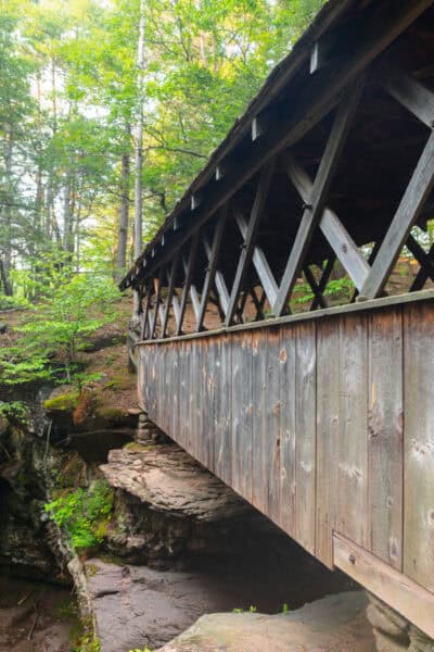 A side view of the wooden covered bridge atop Artist Falls near Cairo, NY