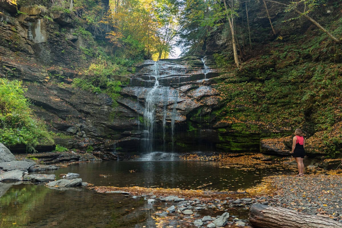 Woman Standing in front of Rexford Falls in Sherburne NY