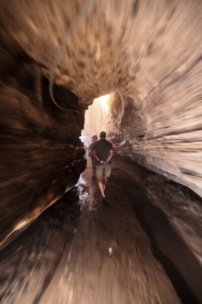 Man walking through a passageway in Secret Caverns in New York.