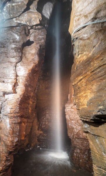 Underground waterfall between rocks in Secret Caverns in Schoharie County New York