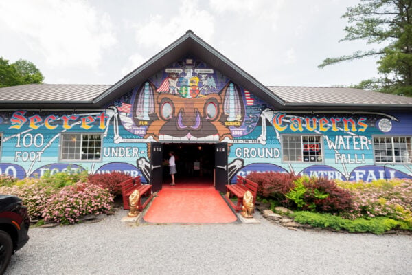 Entrance to the visitor center at Secret Caverns in New York covered in graffiti type art.