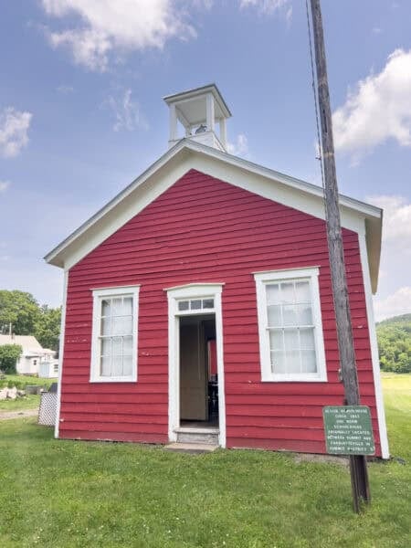 The red exterior of the 1863 Oliver School House at the Old Stone Fort Museum in Schoharie NY